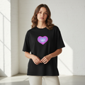 Standing woman wearing LOVE is all there is design on black tee