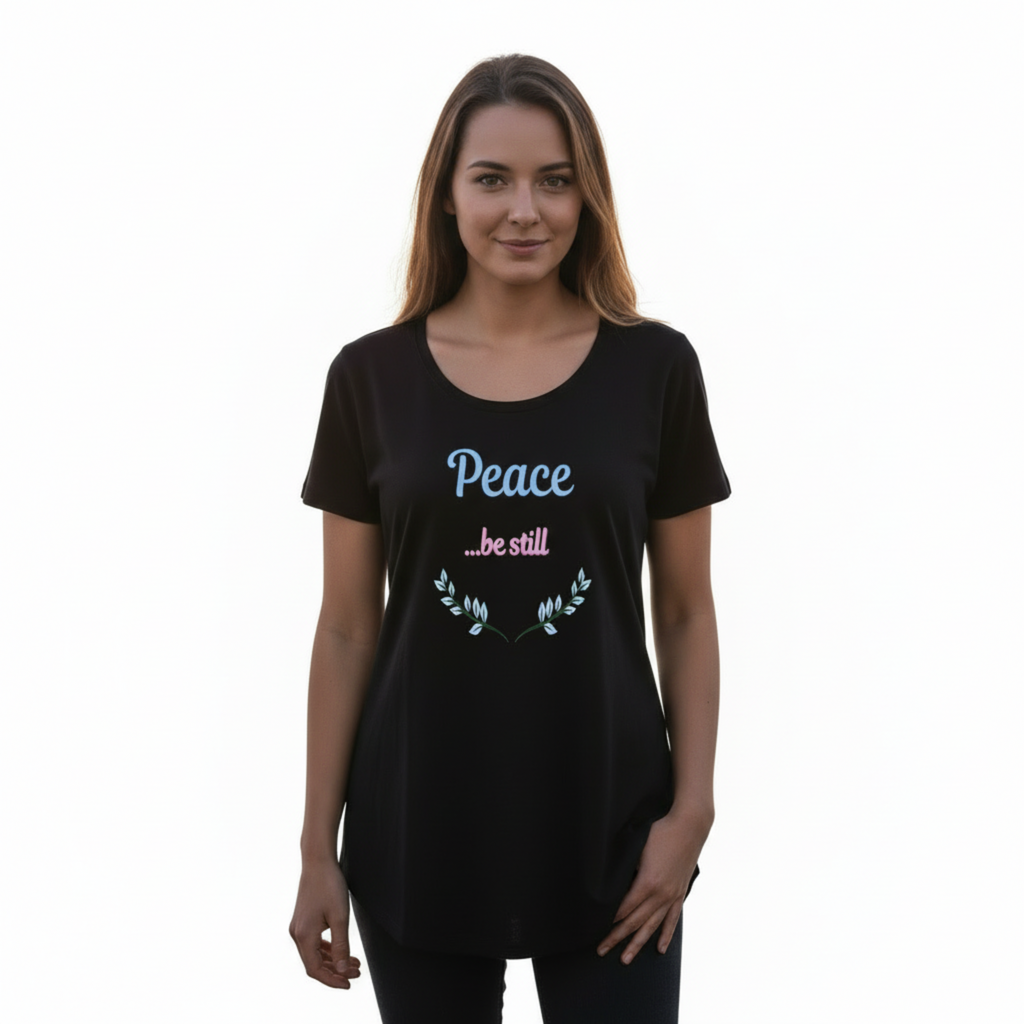 Woman in relaxed pose wearing Peace be still t-shirt with full head visible