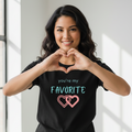 Woman wearing favorite hearts t-shirt making heart hands